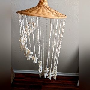 Vintage from the 1970s spiral shell chandelier with wicker top.